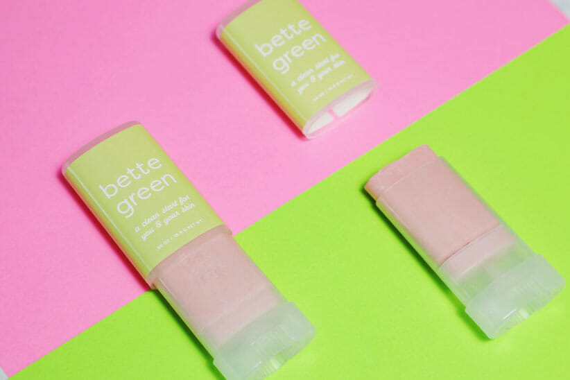 Bella green products on pink and green background 