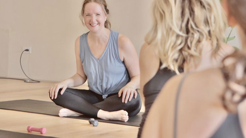 Yoga teacher Claire Hartley smiling wearing yoga clothing teaching yoga
