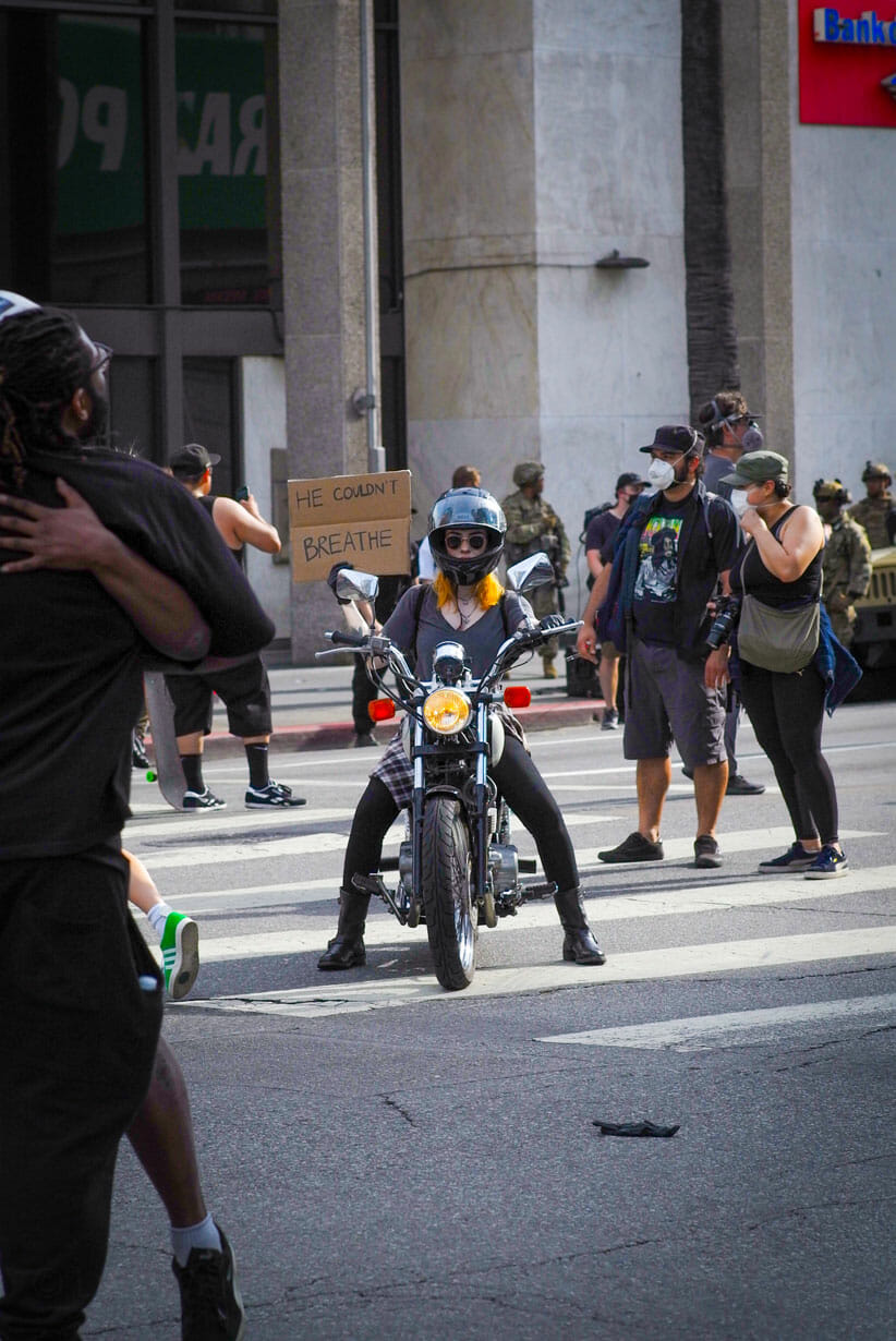 Woman on scooter at protest on Sunset Boulevard and Vine.