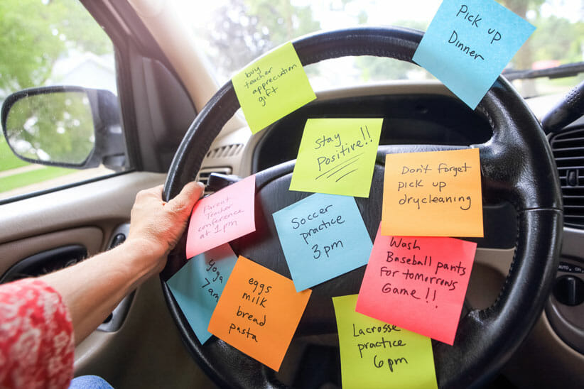 positive affirmation post-it notes on car steering wheel