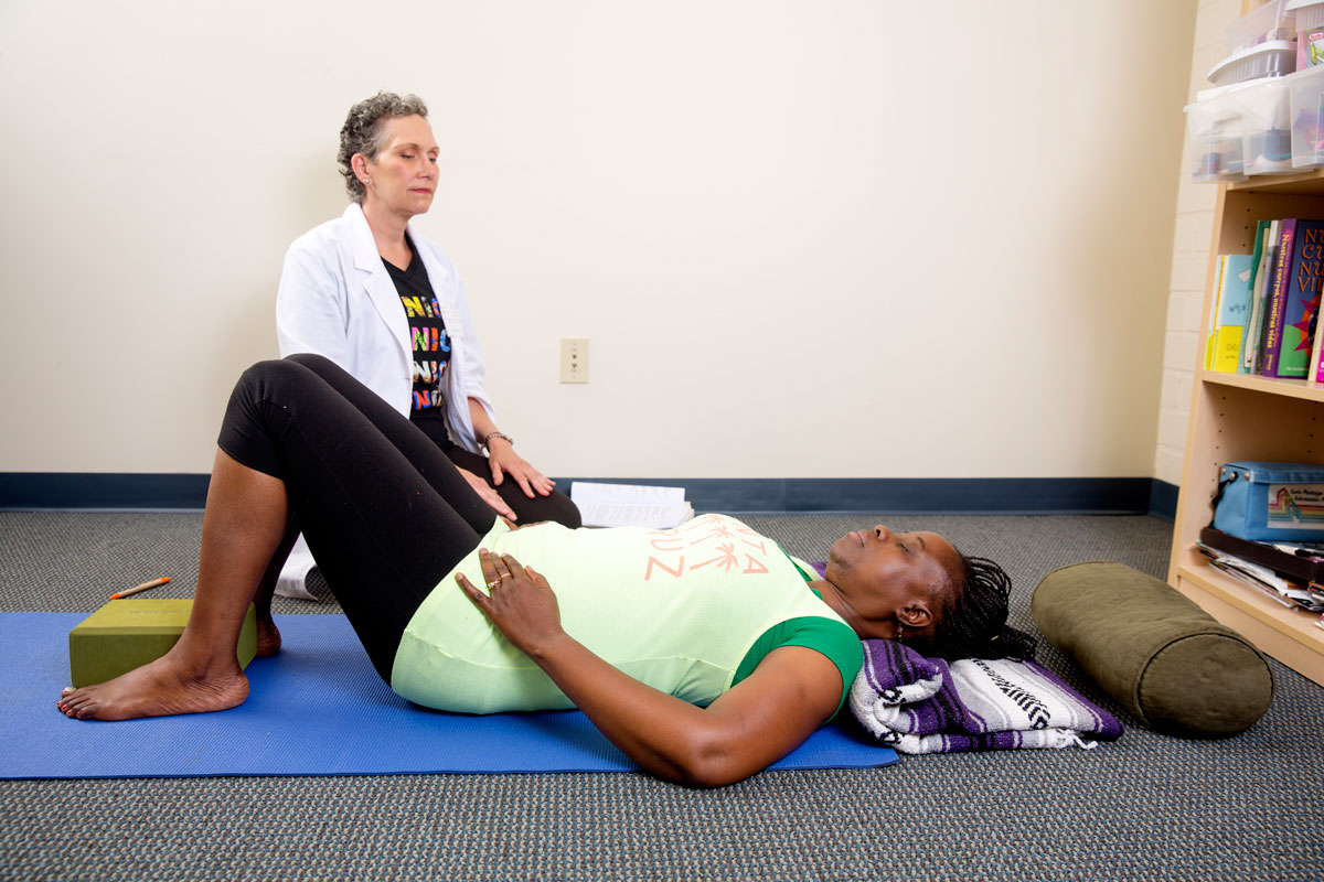 Yoga Therapist Terri Roseman with Student at Venice Family Clinic. Photo by David Young-Wolff. 